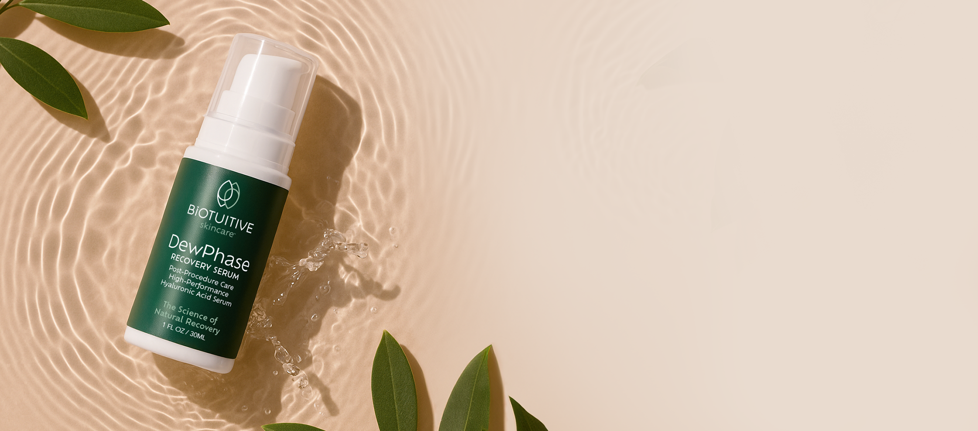 BIOTUITIVE DewPhase Bottle on water against a tan background with leaves